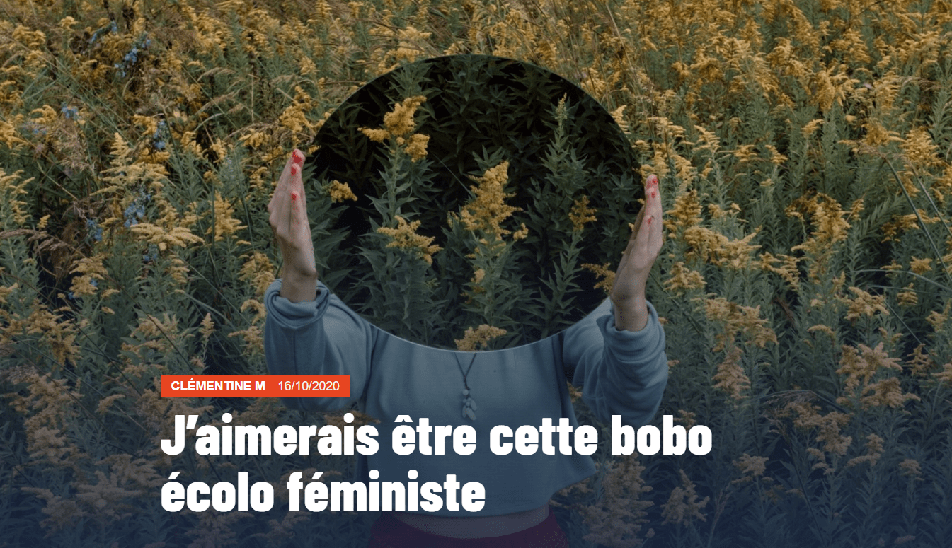 Image du texte « J'aimerais être cette bobo écolo féministe » Dans un champ, une femme tient devant son visage un miroir qui reflète des fleurs.